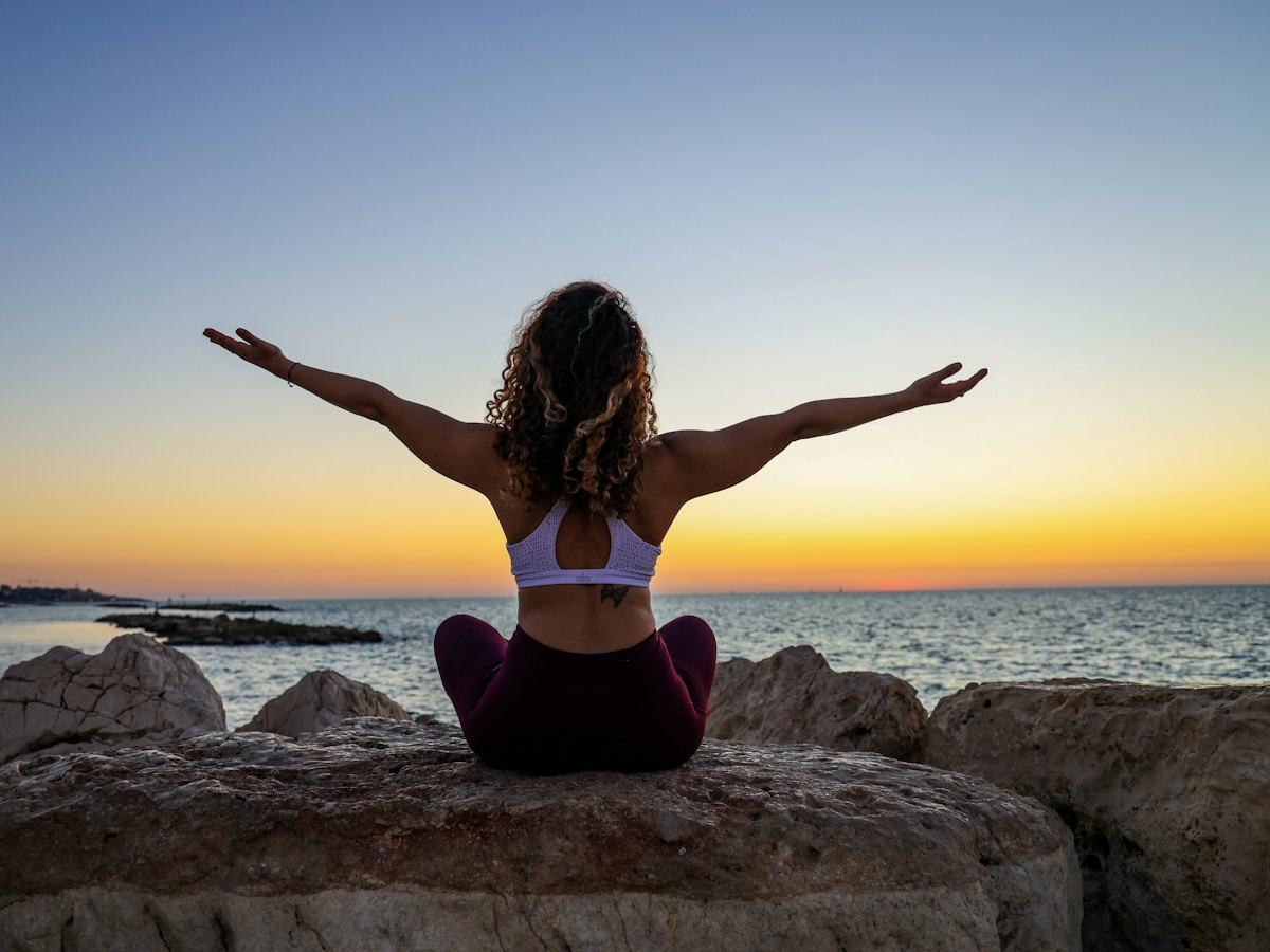A woman sitting quietly by the water