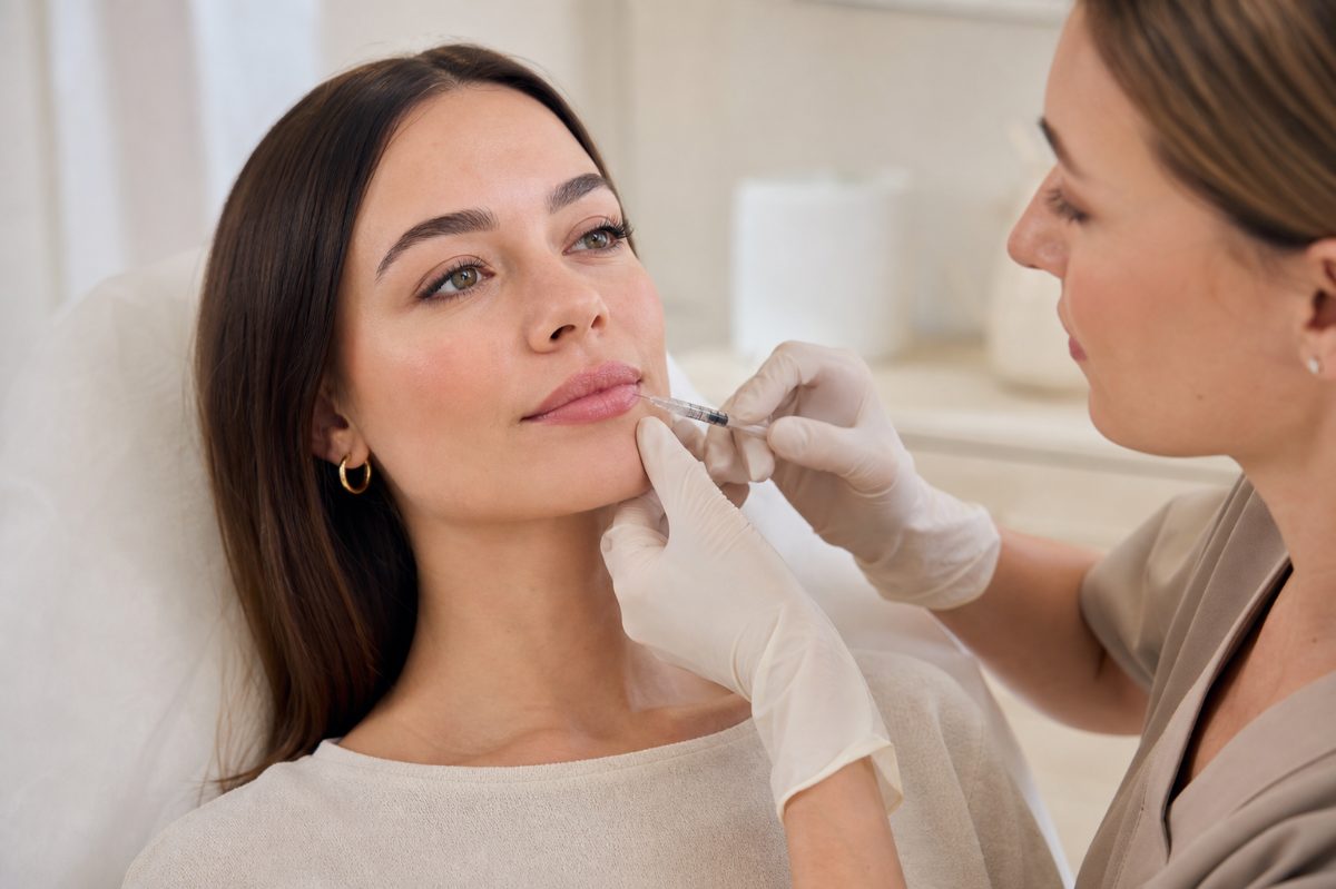 Dermal filler being injected to define a patient’s lips